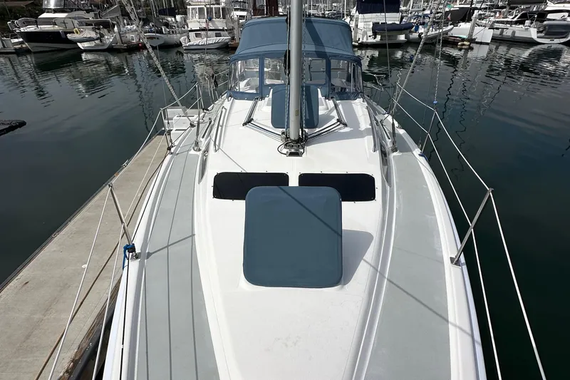 Slide: The Image of 2008 Hunter 36 sailboat docked in marina, featuring sleek deck design. - 18