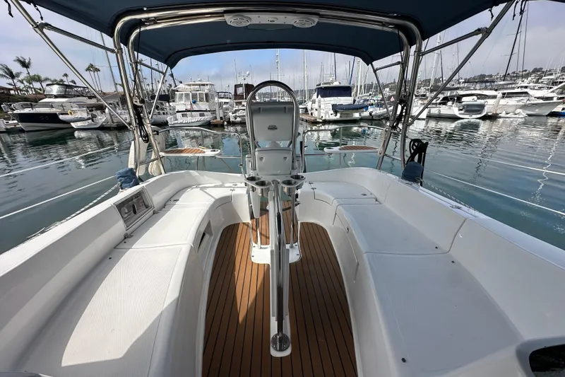 Slide: The Image of 2008 Hunter 36 sailboat cockpit with teak flooring, docked in a marina. - 25