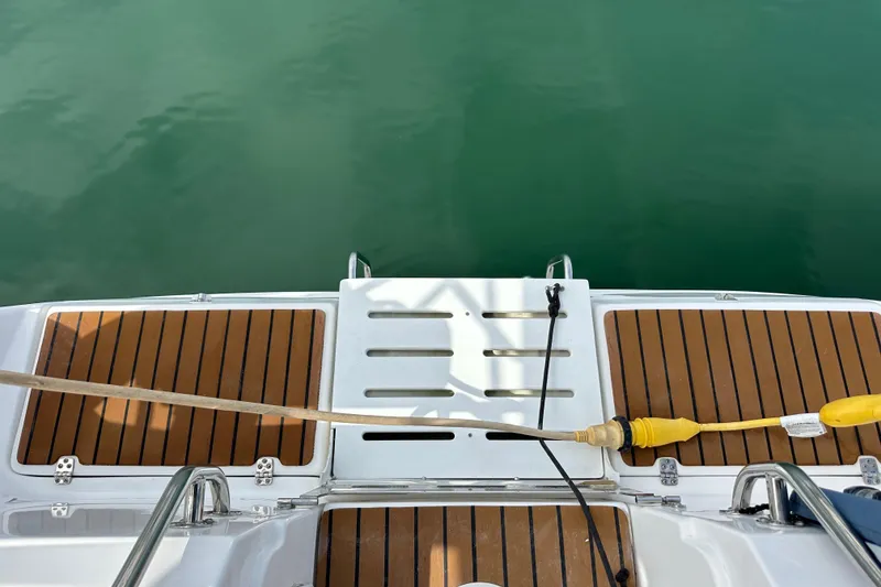 Slide: The Image of Rear deck of a 2008 Hunter 36 boat with teak flooring and water access. - 28