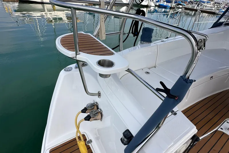 Slide: The Image of 2008 Hunter 36 sailboat stern with stainless steel railings and teak accents in marina. - 29