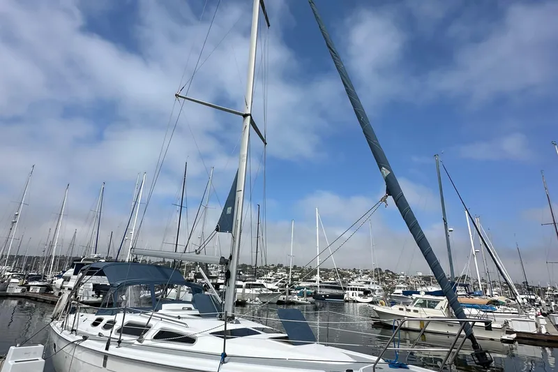 Slide: The Image of Sailboat Hunter 36, 2008 model, docked in a marina under a clear blue sky. - 3