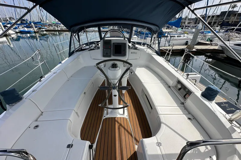 Slide: The Image of 2008 Hunter 36 sailboat cockpit with teak flooring and navigation equipment at marina. - 30