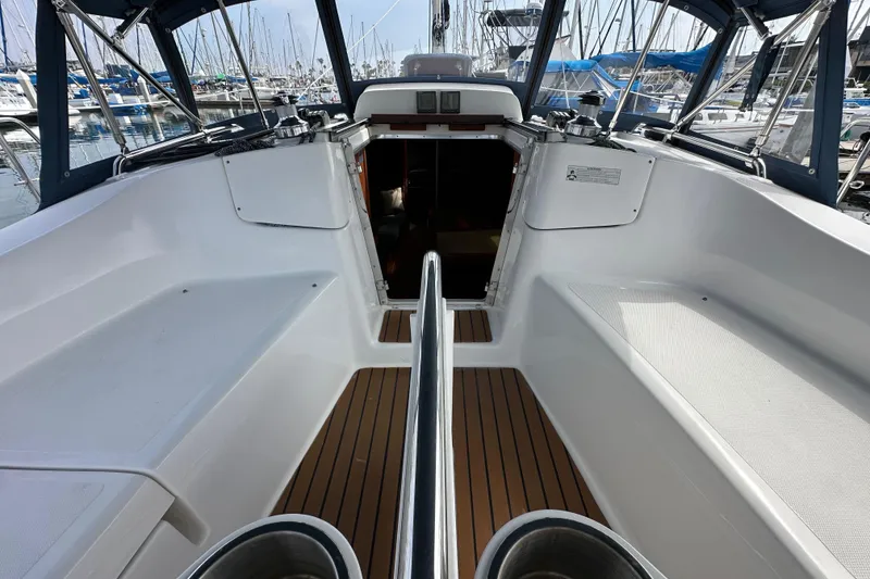 Slide: The Image of 2008 Hunter 36 sailboat cockpit with teak flooring, docked in a marina. - 38