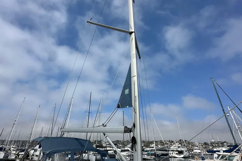 Slide: The Image of 2008 Hunter 36 sailboat mast in a marina under a partly cloudy sky. - 4