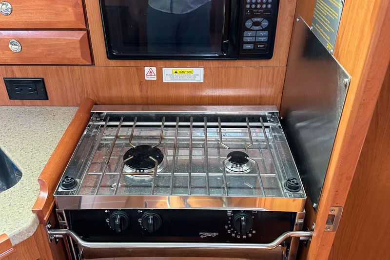 Slide: The Image of Compact kitchen stove and microwave in 2008 Hunter 36 yacht galley. - 47