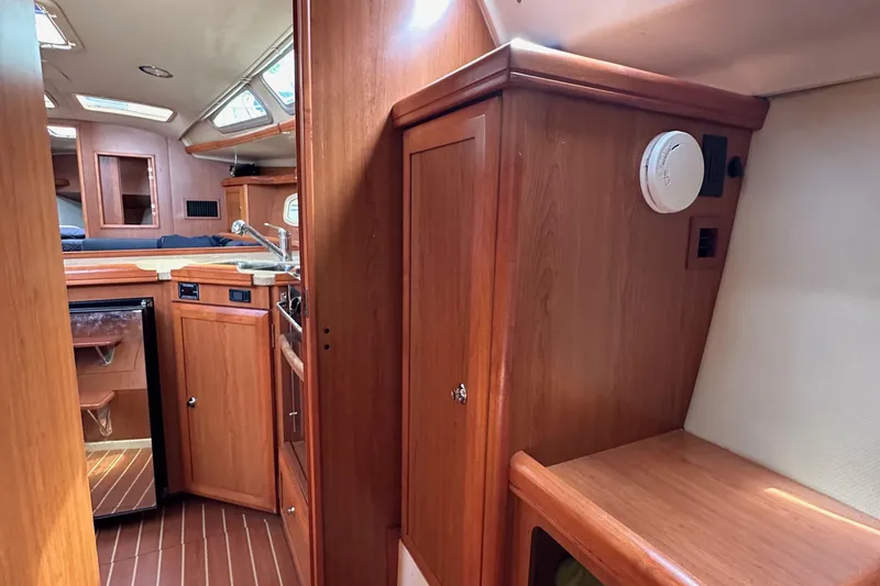 Slide: The Image of Interior of 2008 Hunter 36 sailboat with wood cabinetry and compact kitchen area. - 53