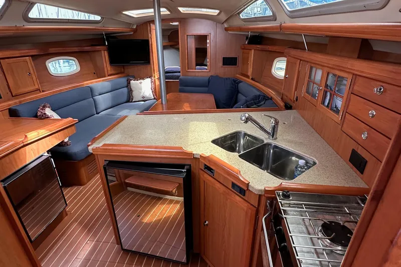 Slide: The Image of Interior of a 2008 Hunter 36 sailboat with modern kitchen and cozy seating area. - 54