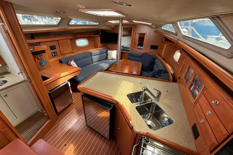 Slide: The Image of Interior of 2008 Hunter 36 sailboat with modern kitchen and cozy seating area. - 55