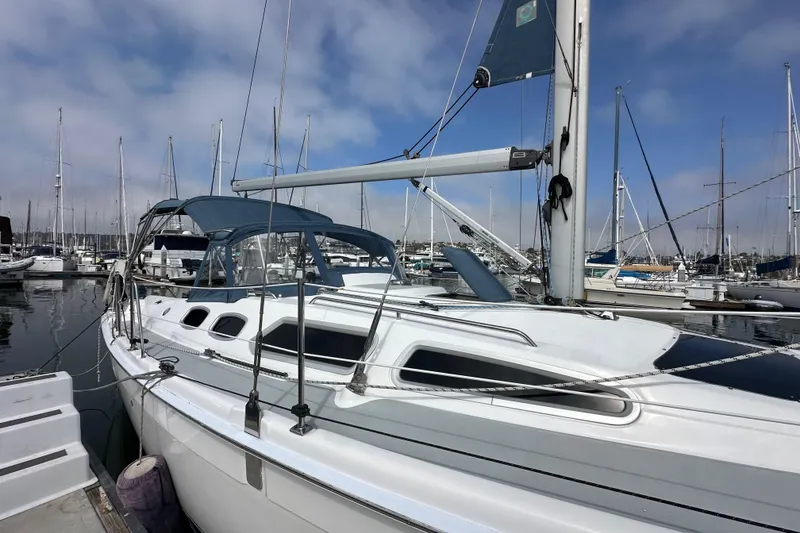 Slide: The Image of 2008 Hunter 36 sailboat docked at marina under clear blue sky. - 6