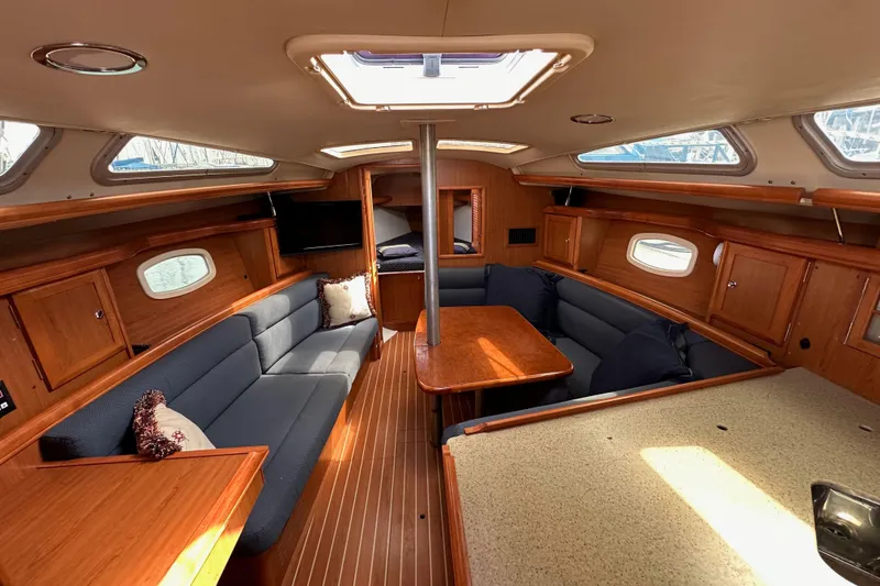 Slide: The Image of Interior of 2008 Hunter 36 sailboat with wood finish and cozy seating area. - 65