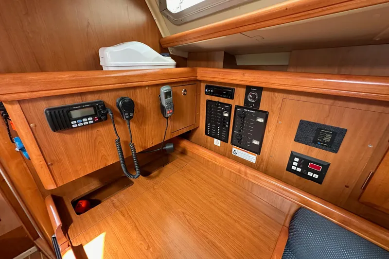 Slide: The Image of 2008 Hunter 36 yacht interior with navigation and communication equipment on wooden panel. - 68