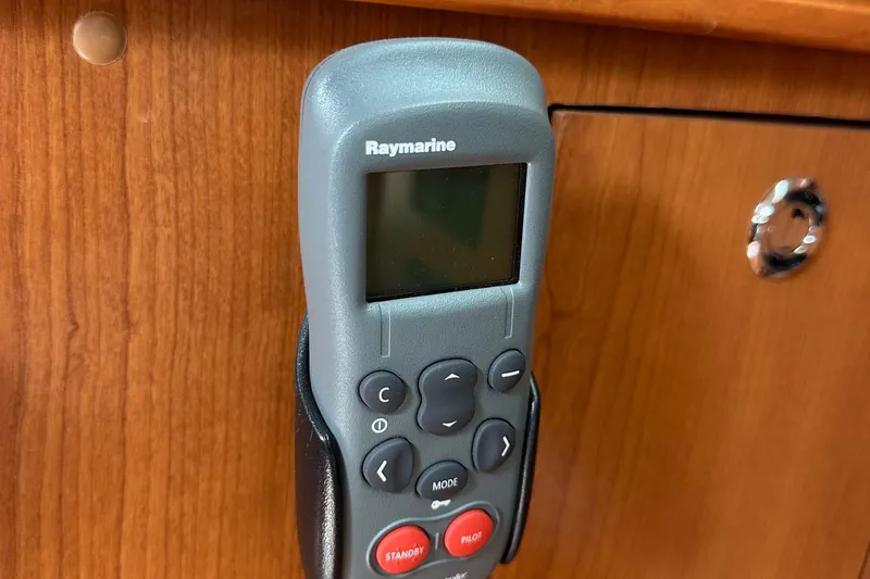 Slide: The Image of Raymarine remote control mounted on wooden panel in 2008 Hunter 36 yacht. - 70