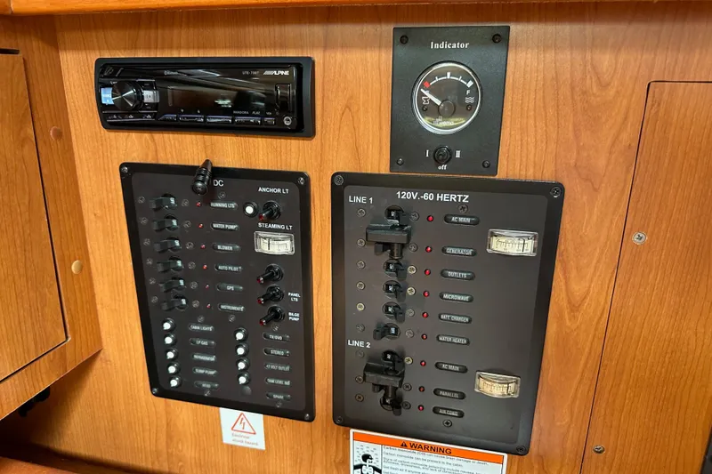 Slide: The Image of Control panel of a 2008 Hunter 36 sailboat with various switches and gauges. - 71