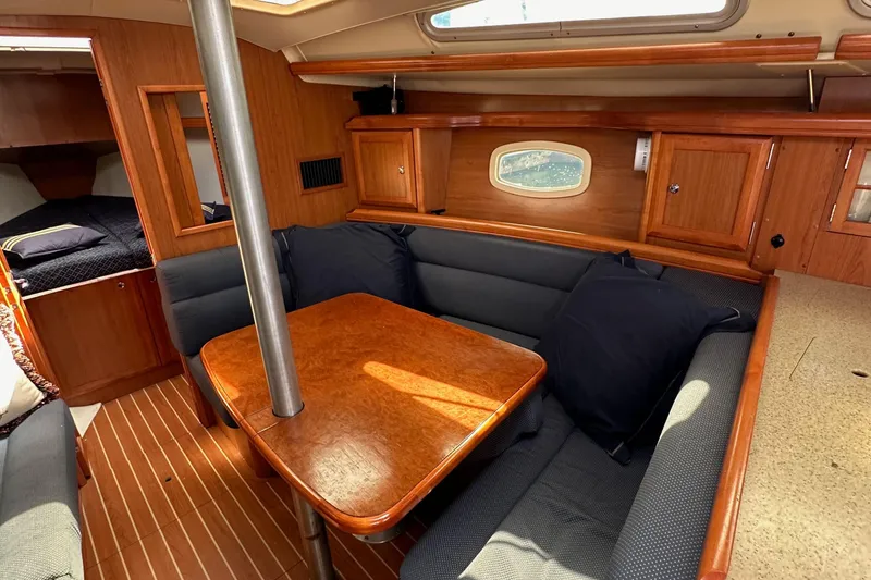 Slide: The Image of Interior of 2008 Hunter 36 sailboat with cozy seating and wooden table. - 74