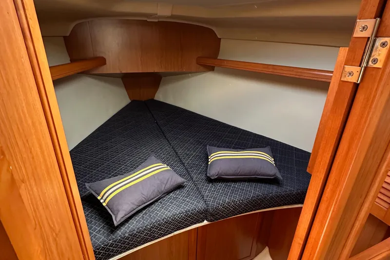Slide: The Image of 2008 Hunter 36 sailboat cabin with cozy V-berth and striped pillows. - 77
