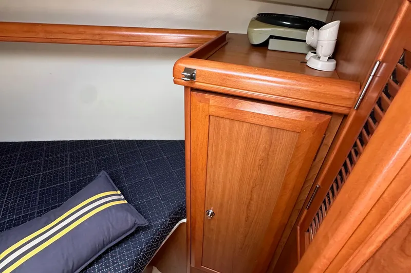 Slide: The Image of Interior of 2008 Hunter 36 sailboat with wooden cabinetry and cozy bedding. - 78