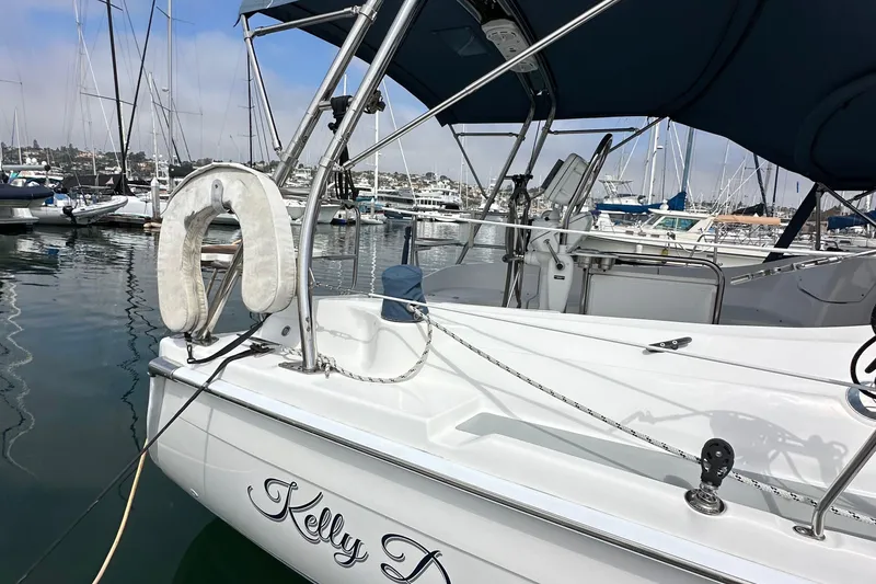 Slide: The Image of 2008 Hunter 36 sailboat docked in marina, featuring sleek design and nautical equipment. - 8