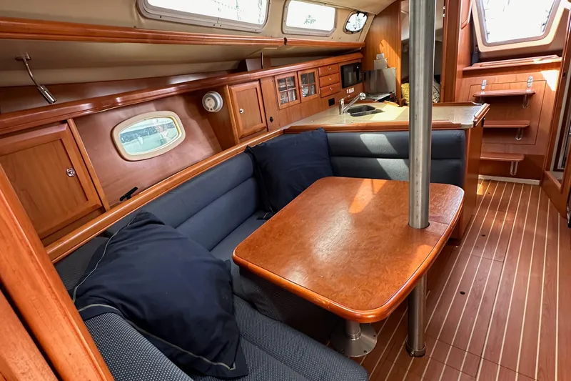 Slide: The Image of Interior of a 2008 Hunter 36 sailboat with wooden furnishings and cozy seating area. - 81