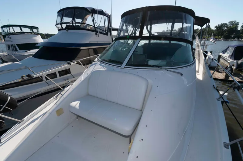 Slide: The Image of 2003 Carver 350 Mariner yacht docked, featuring spacious deck and seating area. - 11