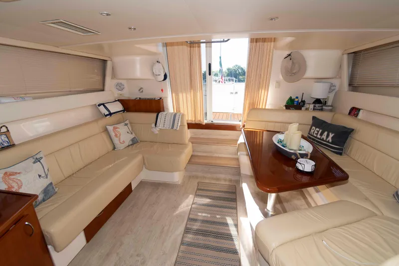 Slide: The Image of Luxurious interior of 2003 Carver 350 Mariner yacht with beige seating and wooden table. - 13