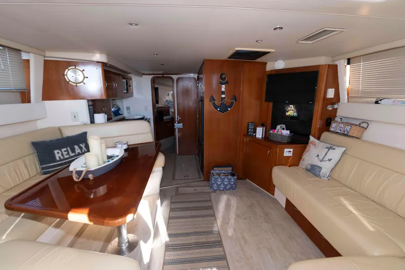 Slide: The Image of Interior of 2003 Carver 350 Mariner yacht with cozy seating and nautical decor. - 14