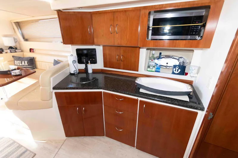 Slide: The Image of Interior of 2003 Carver 350 Mariner yacht with kitchenette and seating area. - 18