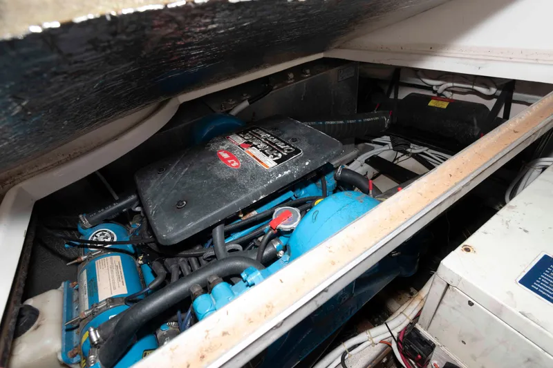 Slide: The Image of Engine compartment of a 2003 Carver 350 Mariner boat, showcasing mechanical components. - 23