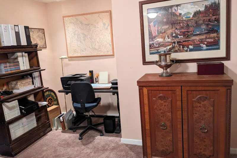 Slide: The Image of Cozy living room with vintage wooden furniture, floral arrangements, and a TV setup. - 10