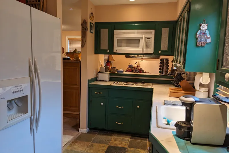 Slide: The Image of Cozy vintage kitchen with floral centerpiece, wooden cabinets, and decorative lighting. - 14