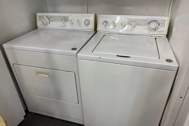 Slide: The Image of Two vintage white washing machines in a boathouse setting, Custom model, year 1801. - 22