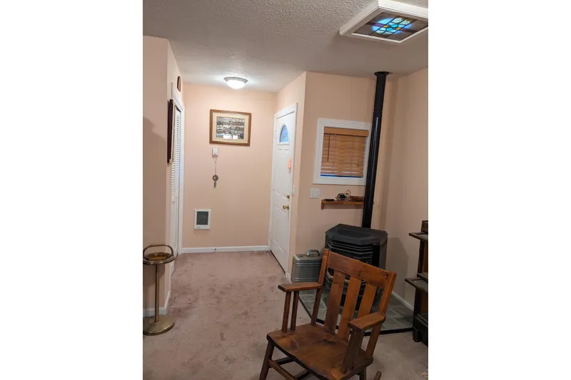 Slide: The Image of Interior of a historic boathouse with water, equipment, and a large door. - 7