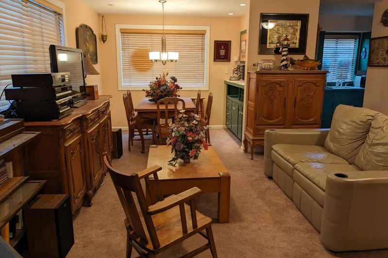Slide: The Image of Cozy interior with wooden chair, stove, and stained glass skylight, in a vintage boathouse setting. - 8