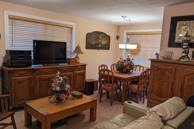 Slide: The Image of Cozy vintage living room with wooden furniture, floral centerpiece, and soft lighting. - 9