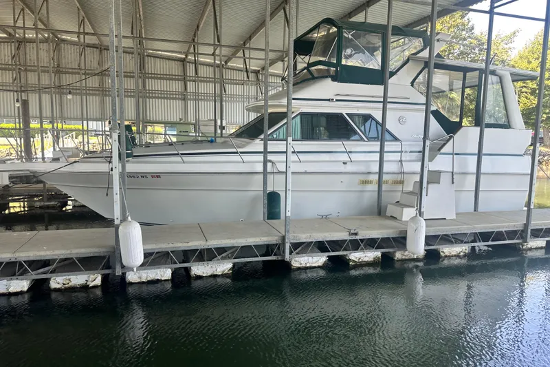 Slide: The Image of 1990 Sea Ray 380 Aft Cabin yacht docked in a covered marina. - 11
