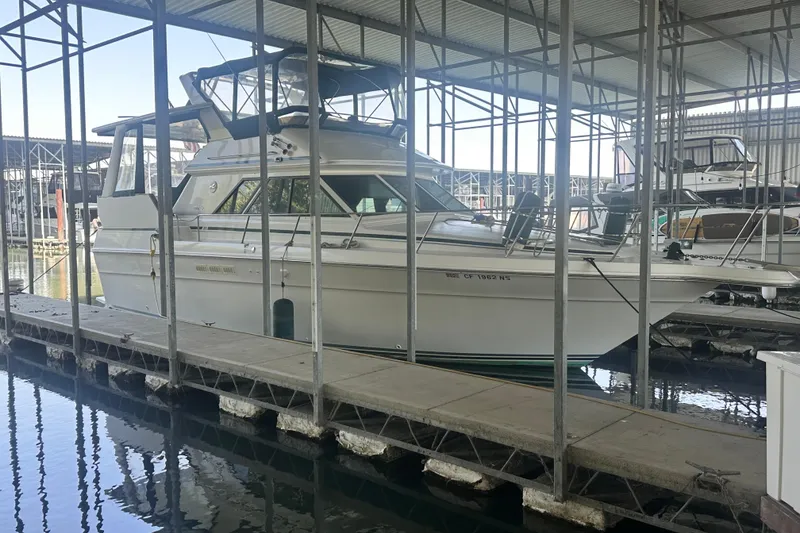 Slide: The Image of 1990 Sea Ray 380 Aft Cabin yacht docked in a covered marina. - 12