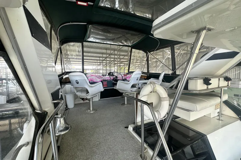 Slide: The Image of 1990 Sea Ray 380 Aft Cabin interior with helm, seating, and life preserver. - 19