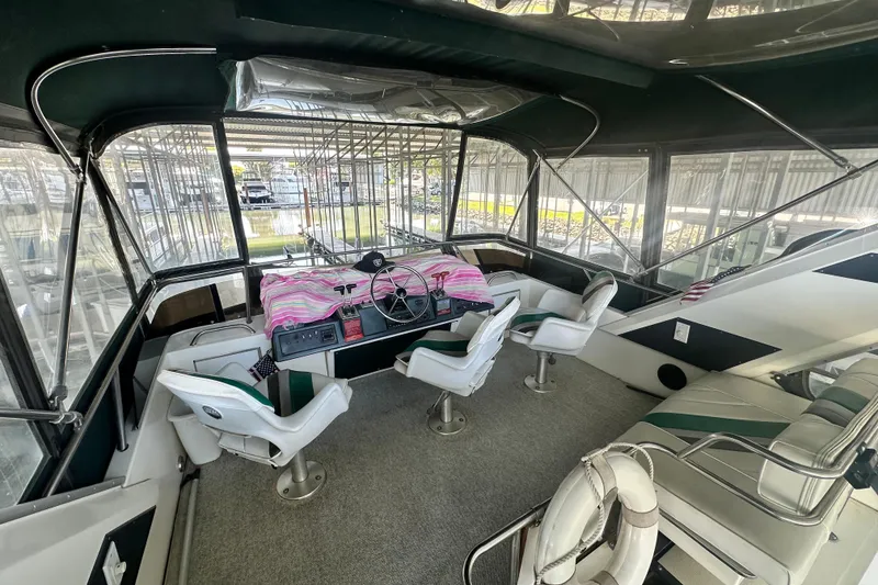 Slide: The Image of 1990 Sea Ray 380 Aft Cabin interior with helm, seating, and panoramic windows. - 20