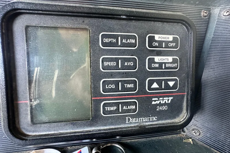Slide: The Image of Control panel of a 1990 Sea Ray 380 Aft Cabin boat, featuring Datamarine DART 2490. - 26