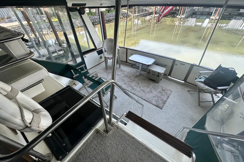 Slide: The Image of 1990 Sea Ray 380 Aft Cabin interior with seating, table, and water view. - 28
