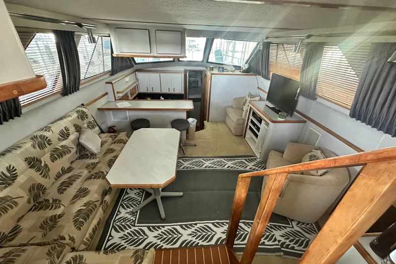 Slide: The Image of Interior of 1990 Sea Ray 380 Aft Cabin with cozy seating and modern amenities. - 29
