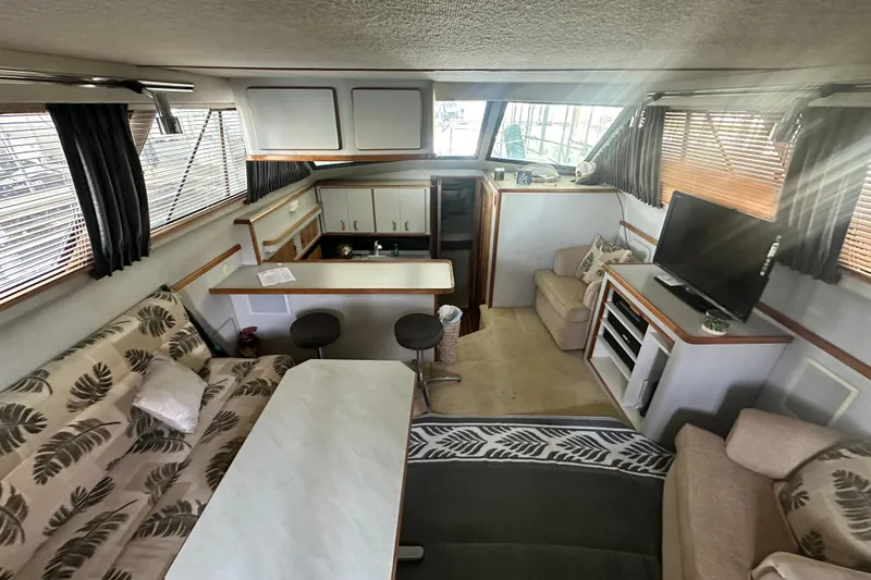 Slide: The Image of Interior of 1990 Sea Ray 380 Aft Cabin with cozy seating and modern amenities. - 31