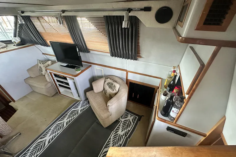 Slide: The Image of Interior of 1990 Sea Ray 380 Aft Cabin with cozy seating and entertainment area. - 33