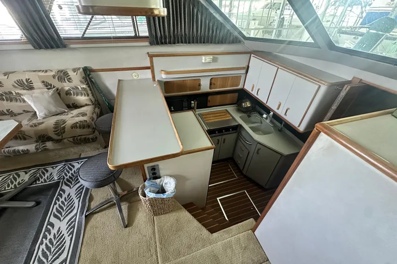 Slide: The Image of Interior of 1990 Sea Ray 380 Aft Cabin yacht with kitchen and seating area. - 36