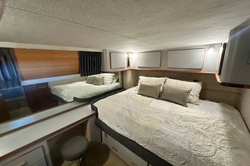 Slide: The Image of Cozy bedroom in 1990 Sea Ray 380 Aft Cabin yacht with elegant bedding. - 41
