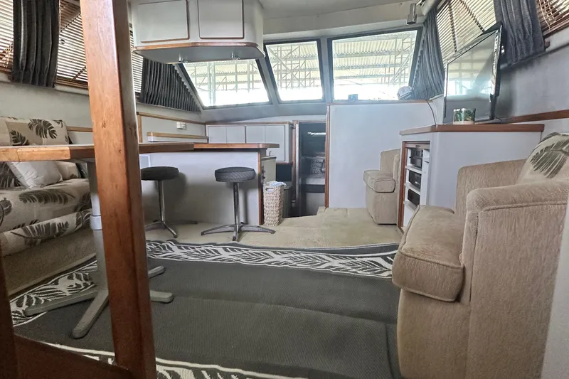 Slide: The Image of Interior of 1990 Sea Ray 380 Aft Cabin yacht with seating and bar stools. - 46