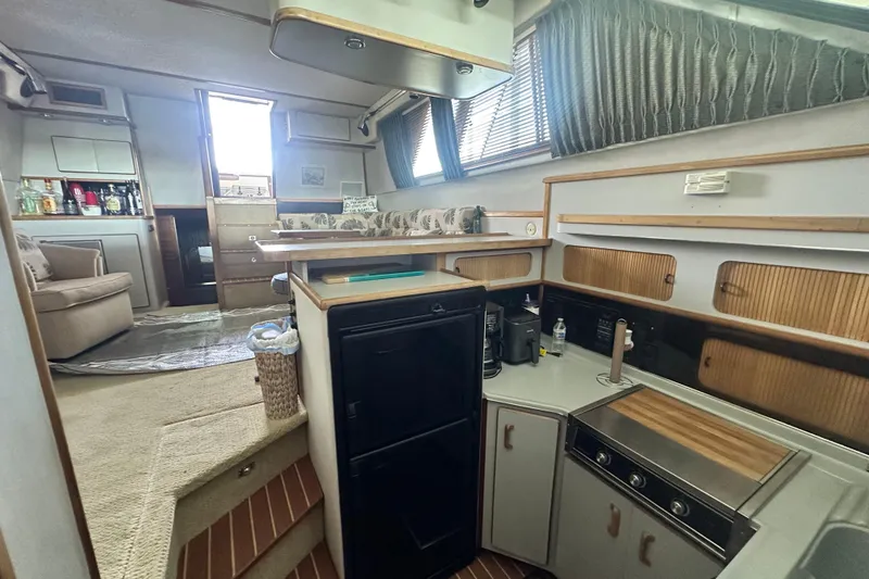Slide: The Image of Interior of 1990 Sea Ray 380 Aft Cabin yacht with kitchen and lounge area. - 50