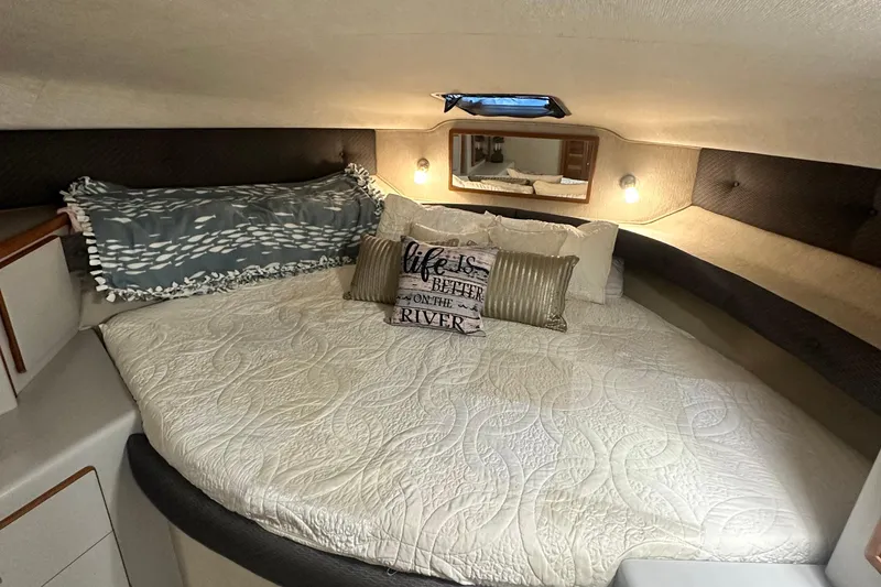 Slide: The Image of Cozy bedroom in 1990 Sea Ray 380 Aft Cabin with decorative pillows and soft lighting. - 55