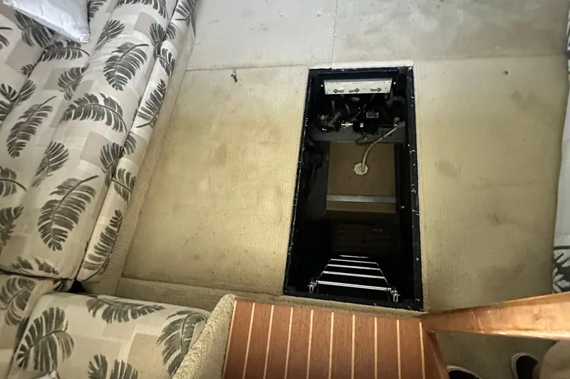 Slide: The Image of Interior of 1990 Sea Ray 380 Aft Cabin with open floor hatch and patterned seating. - 58