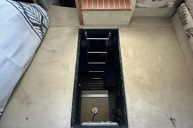 Slide: The Image of Interior view of 1990 Sea Ray 380 Aft Cabin with open floor hatch. - 59