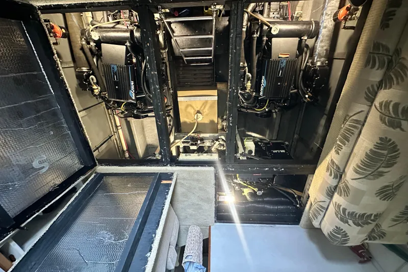 Slide: The Image of Engine room of a 1990 Sea Ray 380 Aft Cabin boat, showing dual engines. - 61